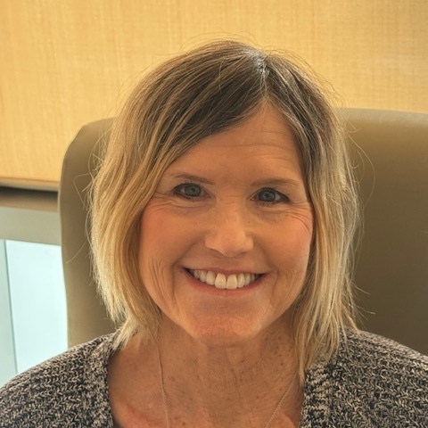 Dana smiling after chemotherapy with her natural hair preserved using cold caps