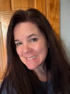 Susan smiling with retained hair after chemotherapy, showing results of cold capping treatment