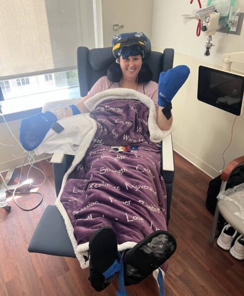 Heather wearing a Penguin cold cap and mitts during chemotherapy