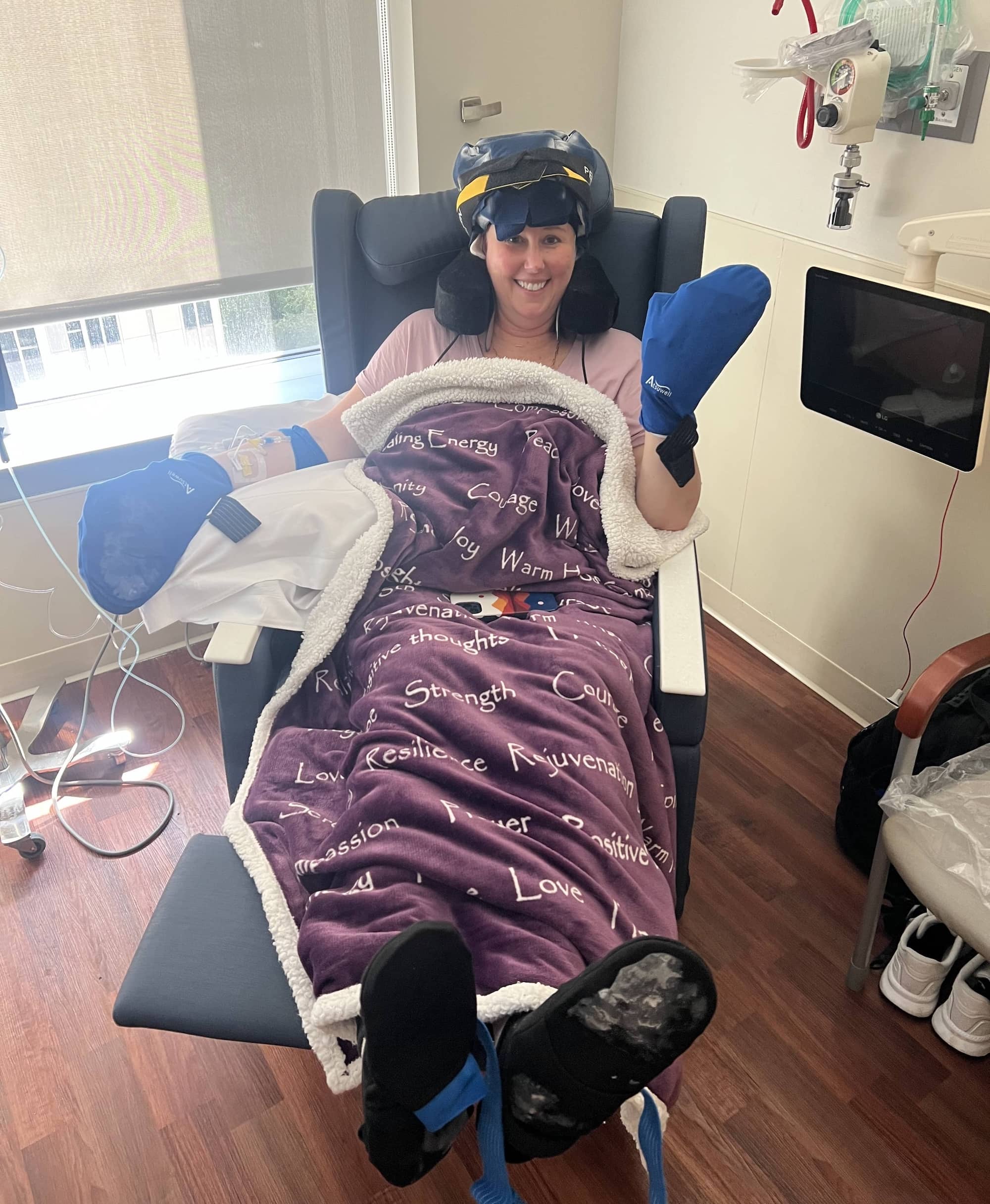 Heather wearing a Penguin cold cap and mitts during chemotherapy